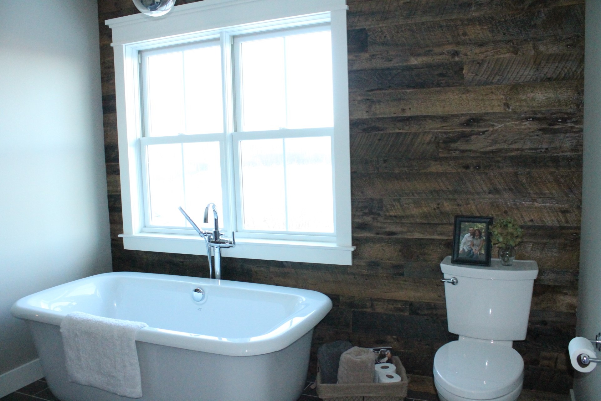 Reclaim style wood accent wall complements the crisp white walls and fixtures.